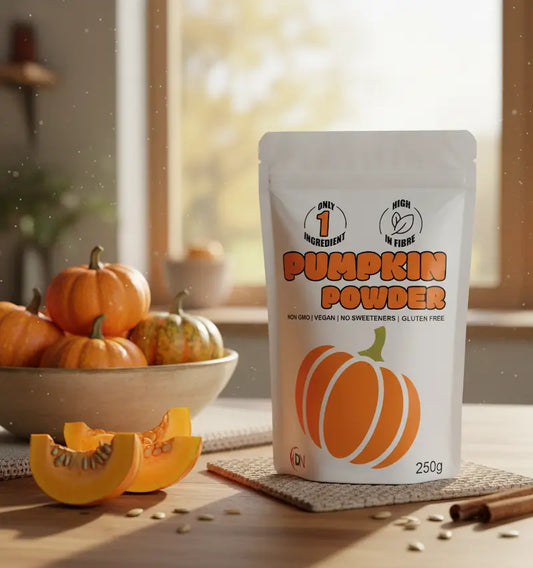 Deluxe Nutrition  Pouch of pumpkin powder with pumpkins and a bowl in the background